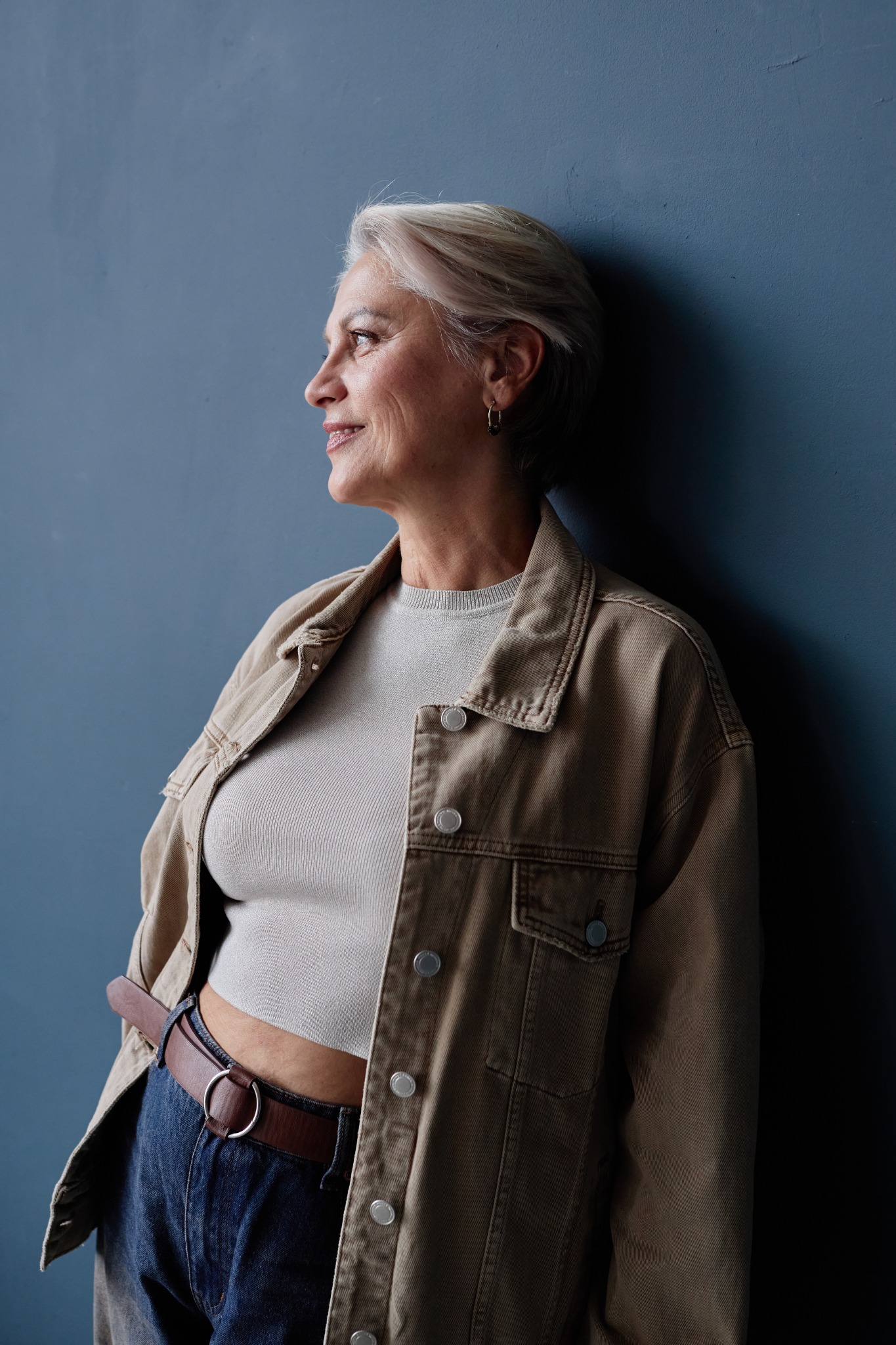 A smiling woman with grey hair, seen in profile